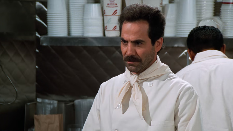 Soup Nazi behind shop counter