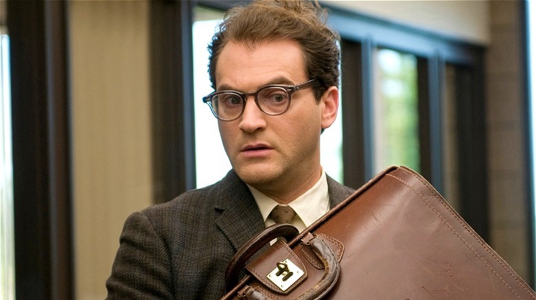 Michael Stuhlbarg holding a briefcase