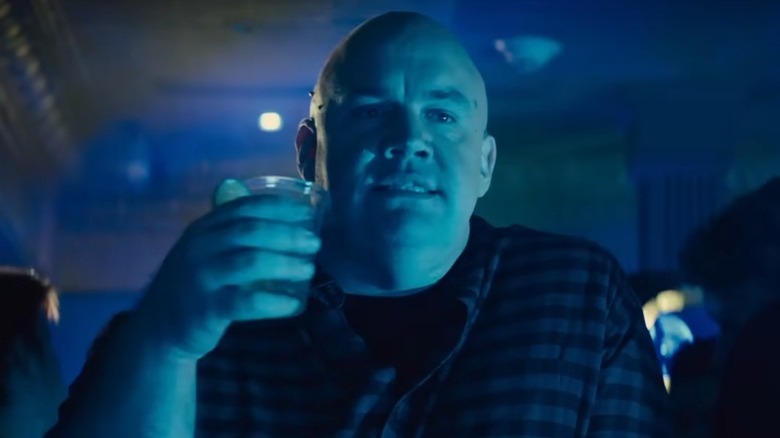 Guy Branum as Henry holding drink in club