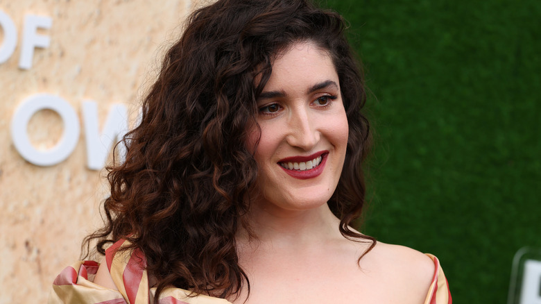 Kate Berlant smiling at a red carpet event