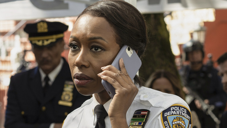 Amanda Warren answers a phone on "East New York"