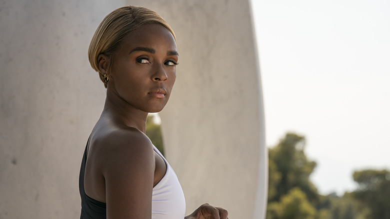 Janelle Monáe peers over her shoulder