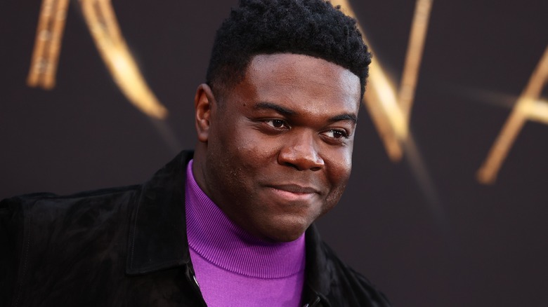 Sam Richardson wearing a purple turtleneck