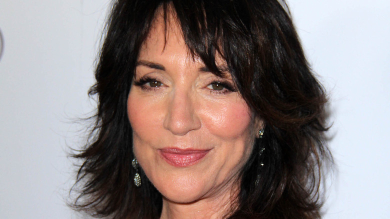 Katey Sagal smiles in front of a white background