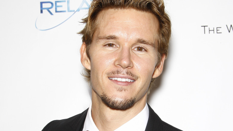 Ryan Kwanten grins.