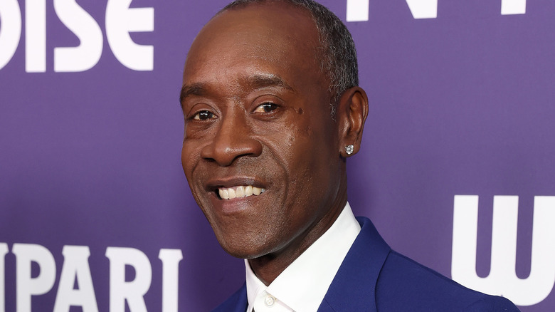 Don Cheadle smiling at a premiere