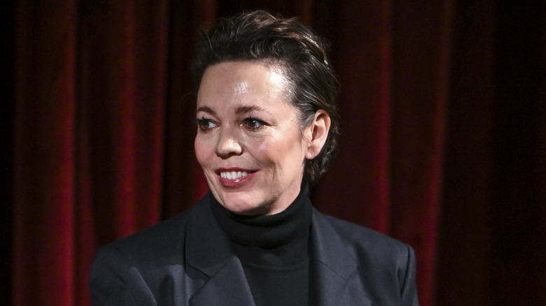 Olivia Colman smiling in a nice suit