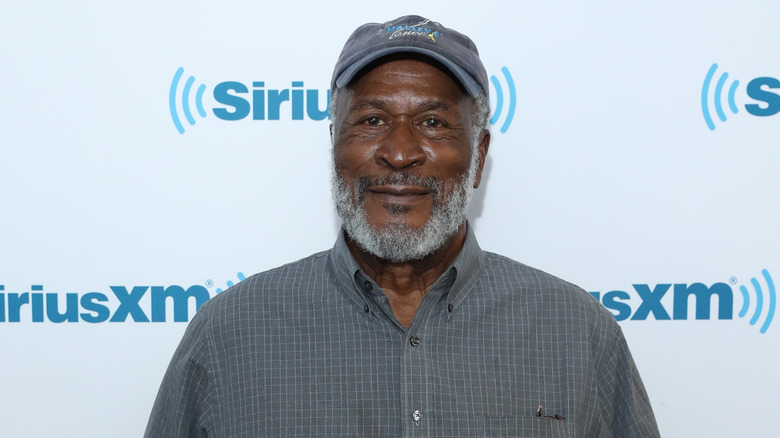 John Amos wearing baseball cap