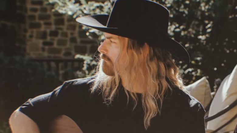 Justin Kucsulain plays a guitar in "Monarch"