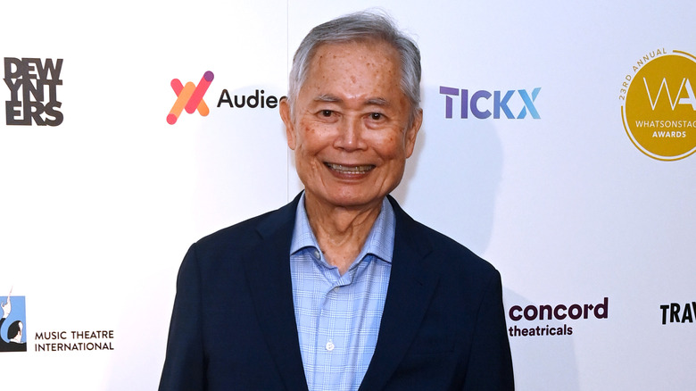 George Takei smiling wearing blazer