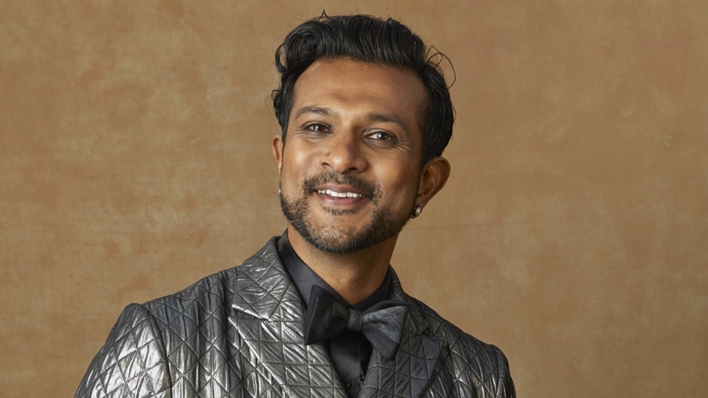 Utkarsh Ambudkar smiling wearing suit