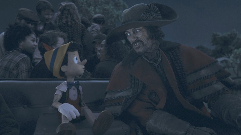 The coachman talking to Pinocchio