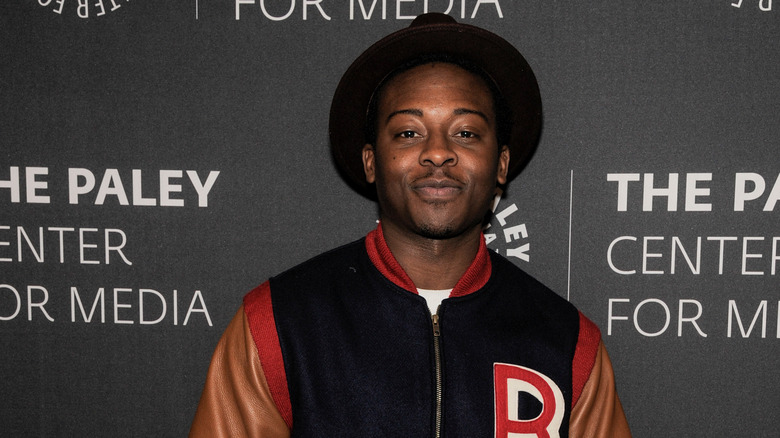 Brandon Micheal Hall wearing varsity jacket