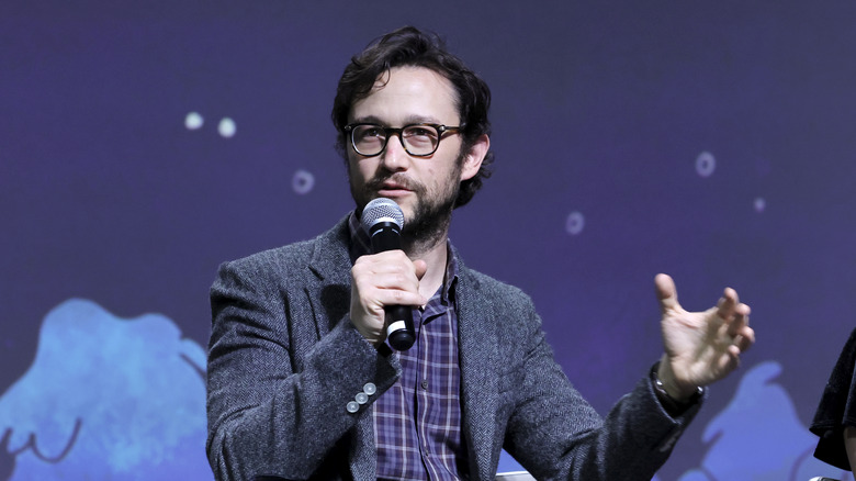 Joseph Gordon-Levitt holds a microphone