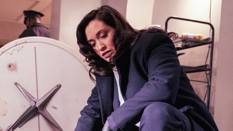 Detective Paley crouching down