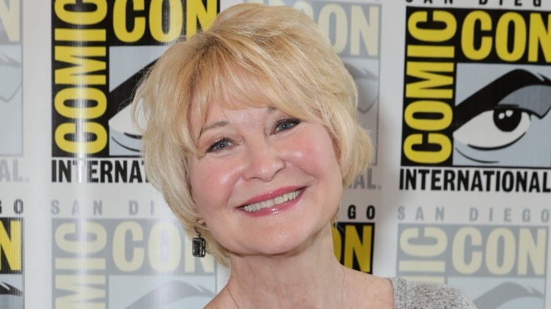 Dee Wallace smiling arms folded