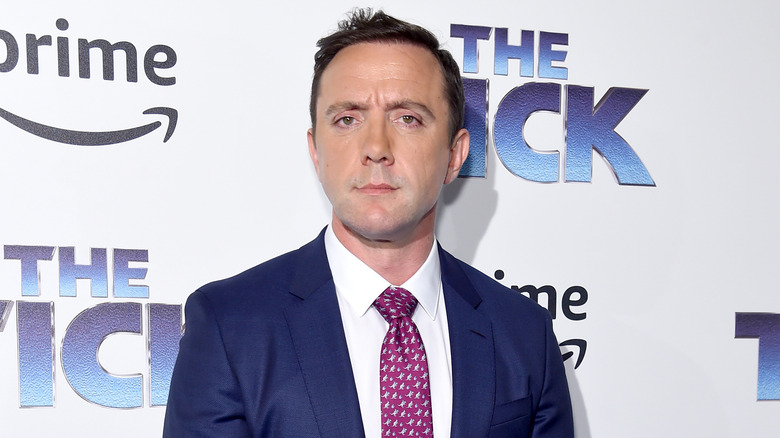 Peter Serafinowicz wearing a blue suit