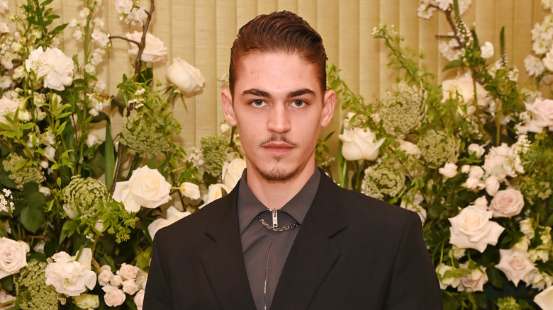 Hero Fiennes Tiffin wearing a necklace