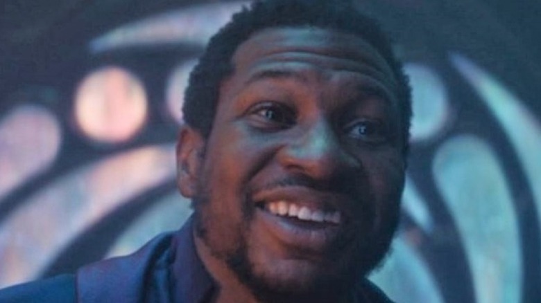 Jonathan Majors smiles as He Who Remains