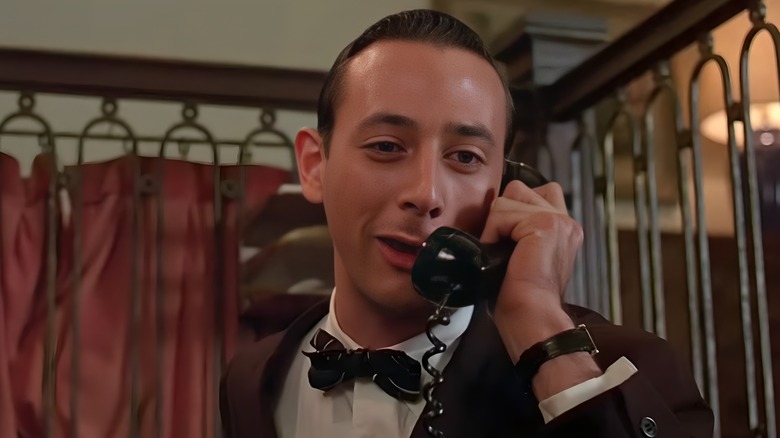 The bellhop smugly talking on the phone