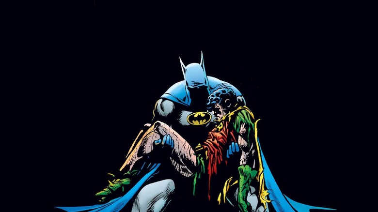 Batman holding Robin's body