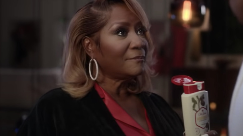 Patti LaBelle holding Old Spice bottle