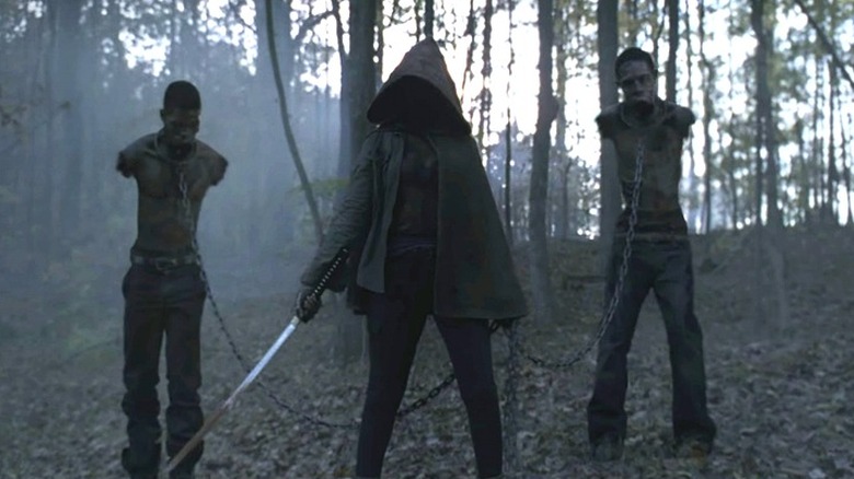 Michonne flanked by her walker pets