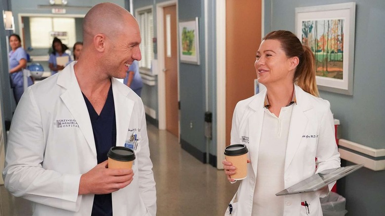 Cormac and Meredith smiling in the hallway on Grey's Anatomy