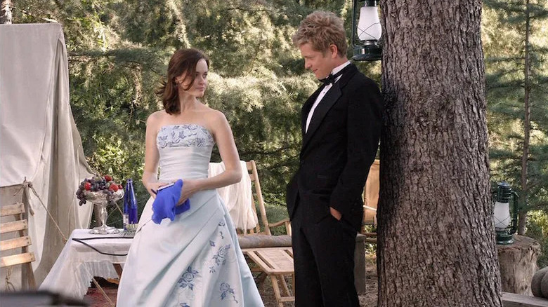 Rory and Logan in the woods in formalwear on Gilmore Girls