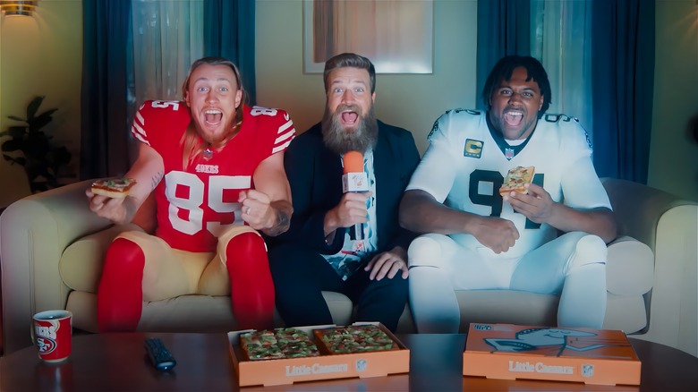 George Kittle, Ryan Fitzpatrick, and Cameron Jordan eating pizza