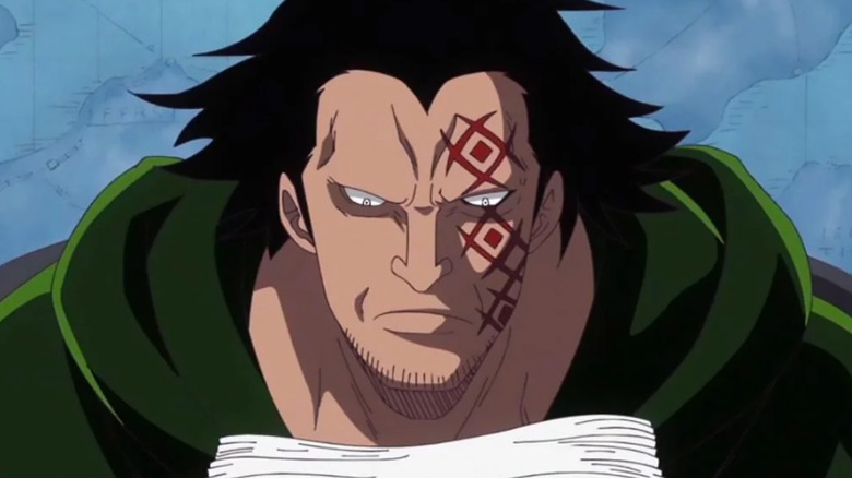 Luffy's father Dragon with a red face tattoo reading a stack of pages