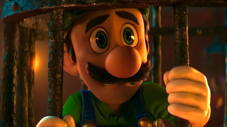 Luigi is looking worried behind iron bars