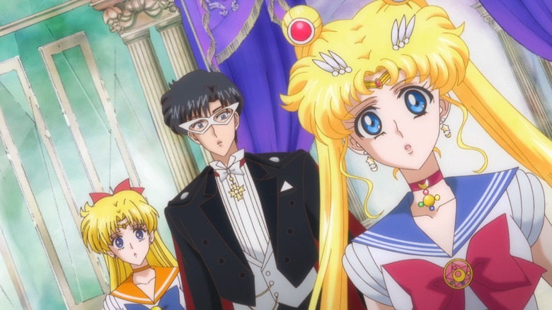 Sailor Venus, Tuxedo Mask, and Sailor Moon look on