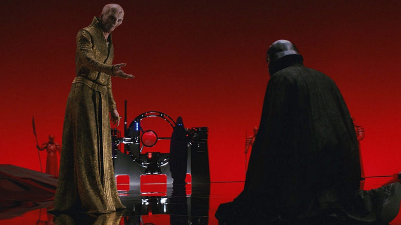 Kylo Ren kneeling before Snoke