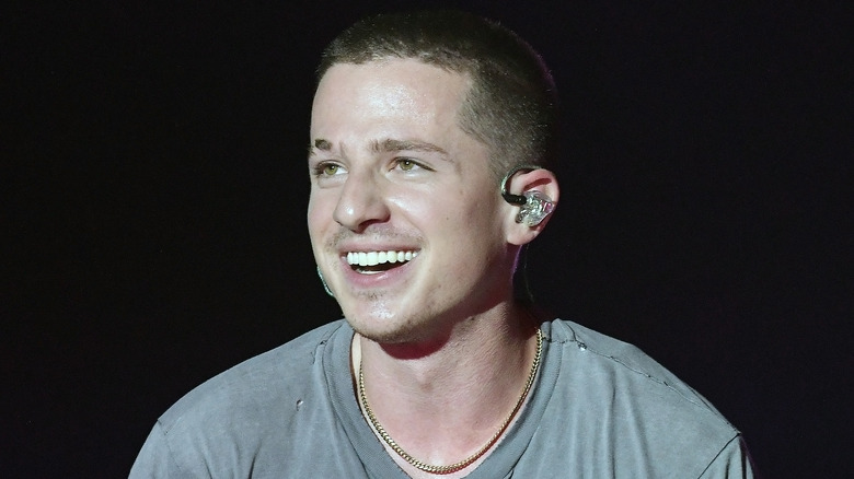 Charlie Puth ear piece white teeth singing