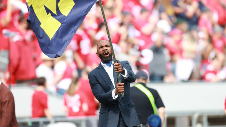 Charles Woodson waving Michigan flag