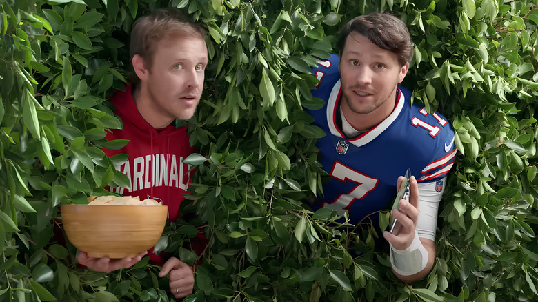 Josh Allen and football fan peeking out of bushes