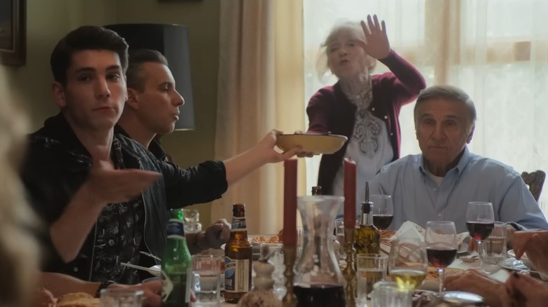 Mama Russo standing behind family at dinner table