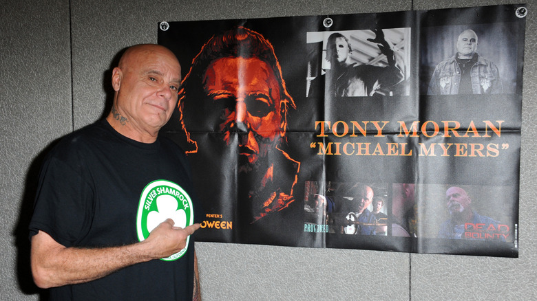 Tony Moran pointing to Halloween poster 