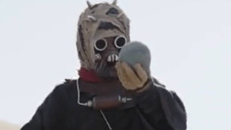 Tusken Kid holding something