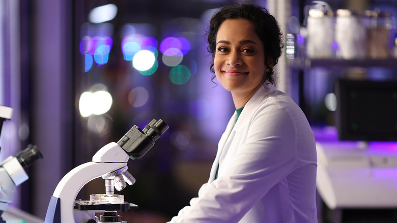 Antoinette Benneteau smiling next to microscope