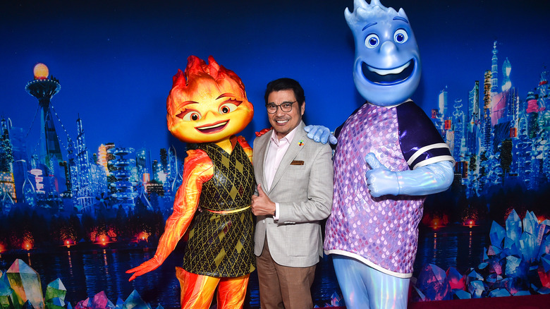 Ronnie Del Carmen posing with costumed characters