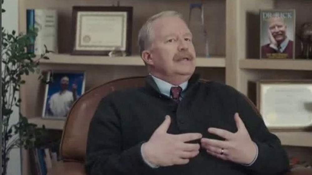 Bill Glass at desk in sweater