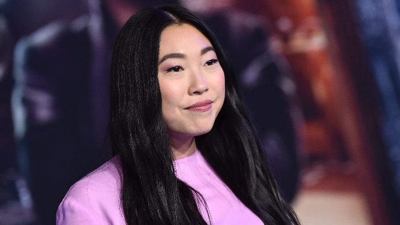 Awkwafina smiling for cameras