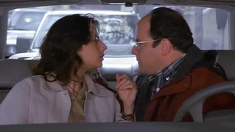 Siena and George sitting in the front seats of a car