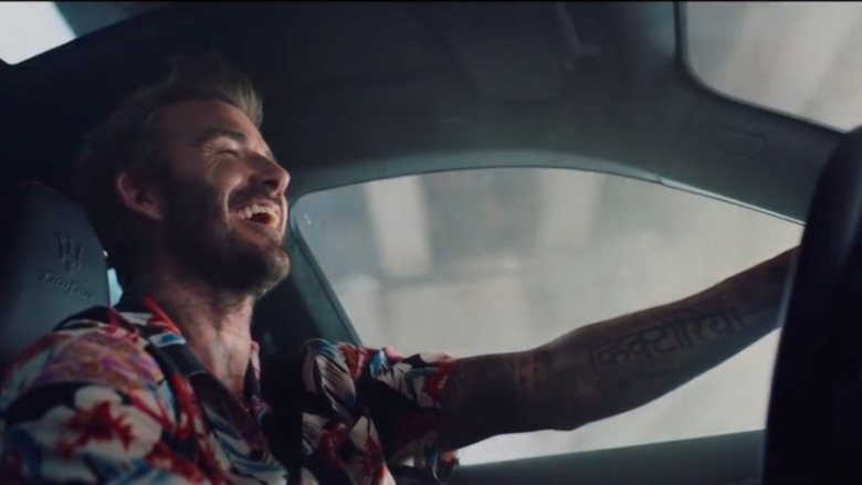 David Beckham driving and laughing