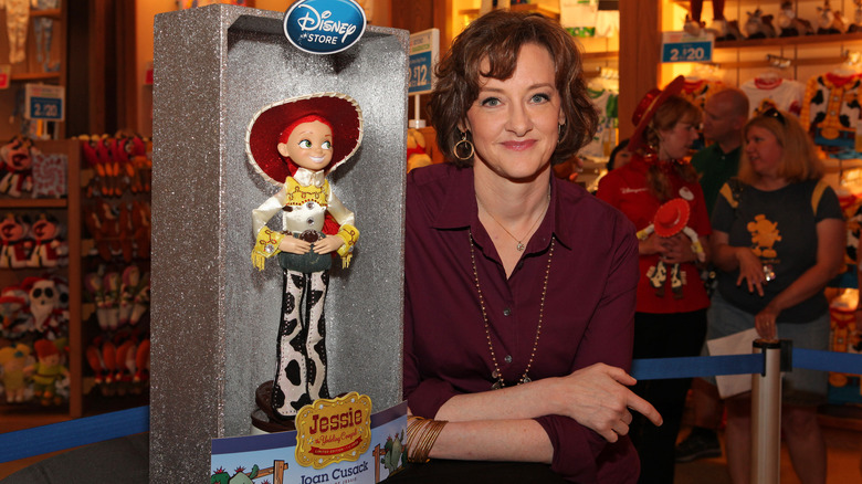 Joan Cusack posing alongside Jessie toy