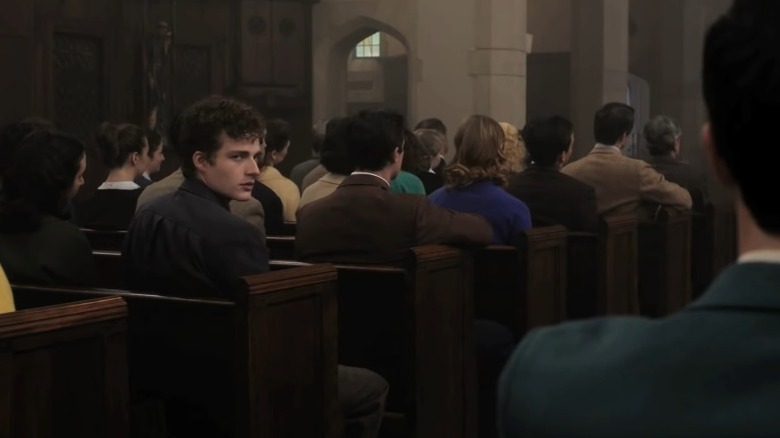 Bertram Flusser looks at Marcus Messner over his shoulder in a church