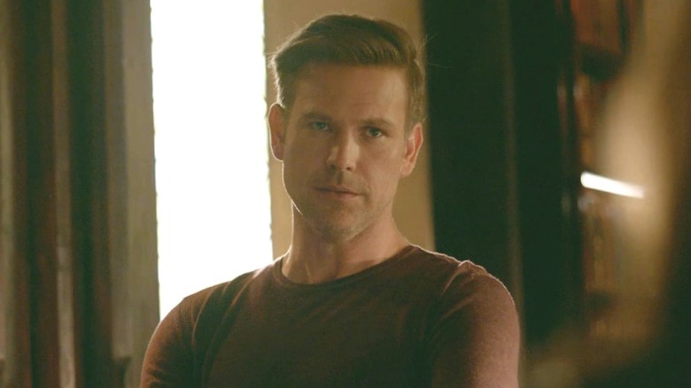 Alaric with arms crossed