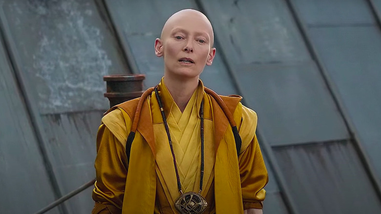 Tilda Swinton bald and in yellow costume